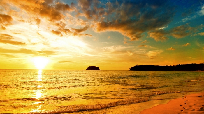 Sunset over the ocean with islands and beach