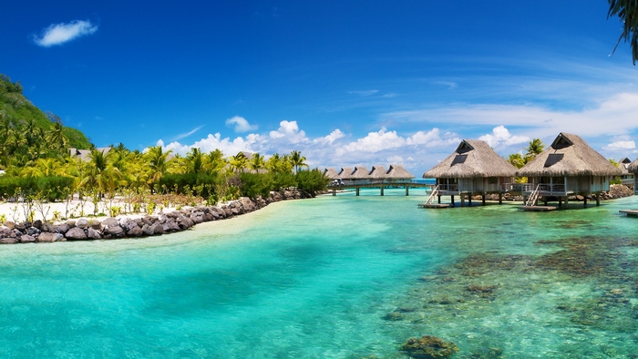 Overwater bungalows in a tropical turquoise lagoon