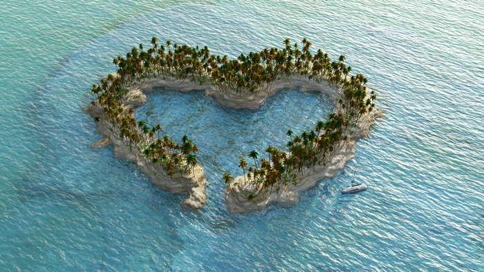 Heart-shaped island with palm trees and a boat