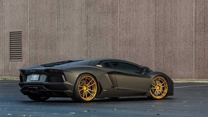 Matte black Lamborghini Aventador with gold wheels