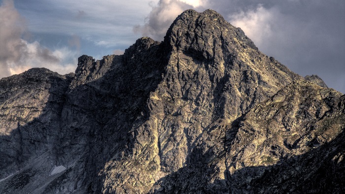 Imposing Mountain Peak under Cloudy Afternoon Sky