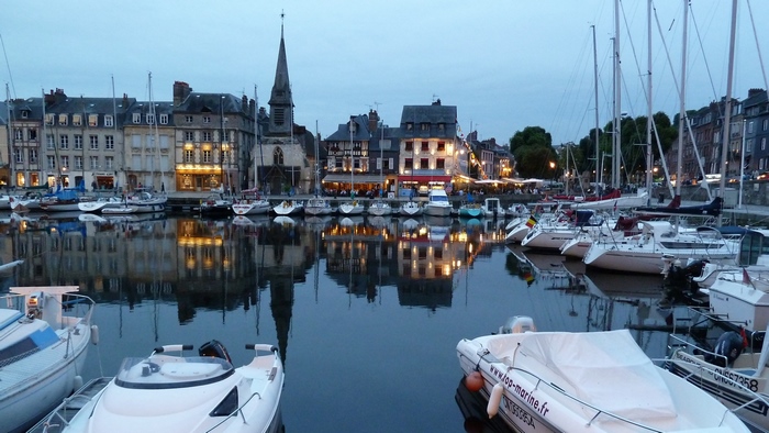 Boats docked in a harbor with historic buildings