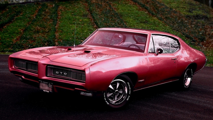 Pink 1969 Pontiac GTO parked on asphalt