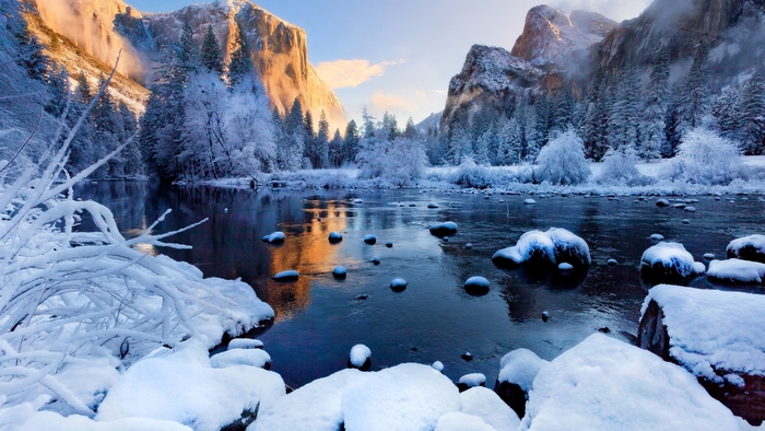 Winter scene with snow-covered trees and a river