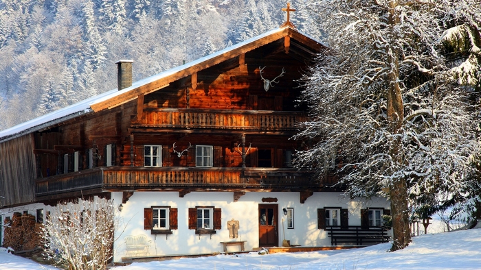 Snow-Covered Wooden Chalet in Winter Mountain Landscape