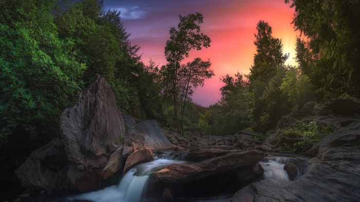Serene Waterfall in Forest at Sunset