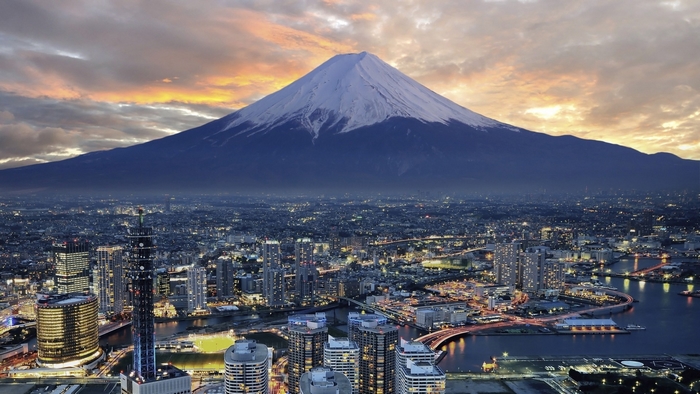 Mount Fuji overlooking Yokohama cityscape at dusk