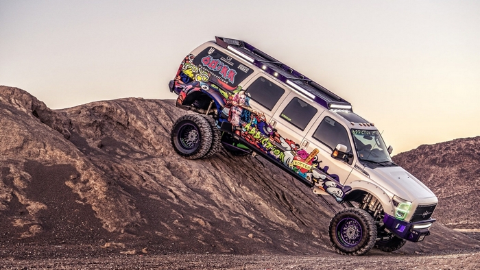 Custom Ford SUV climbing a rocky hill