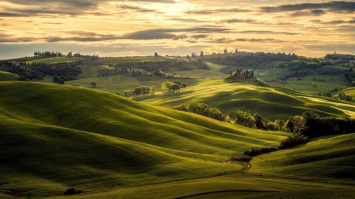 Rolling hills of Tuscany, Italy at sunset