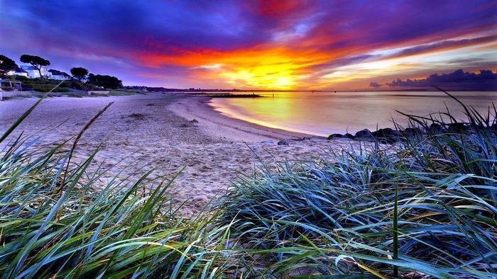 Beach sunset with dramatic clouds and ocean waves