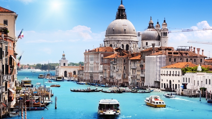 Venice canals with Santa Maria della Salute church and boats