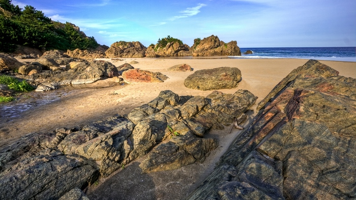 Rocky beach with ocean and blue sky