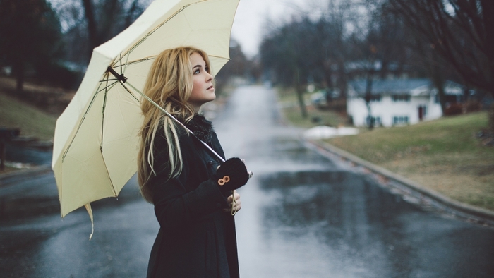 Girl with umbrella on a rainy street