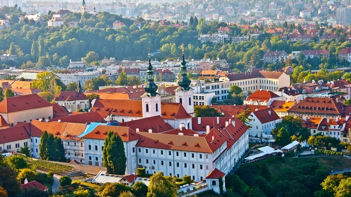 Cityscape with churches and red roofs in Prague, Czech Republic