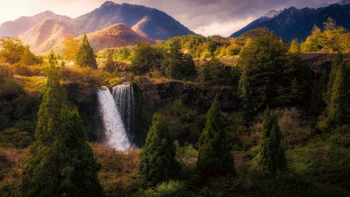 Waterfall cascading down a rocky cliff in a mountain landscape