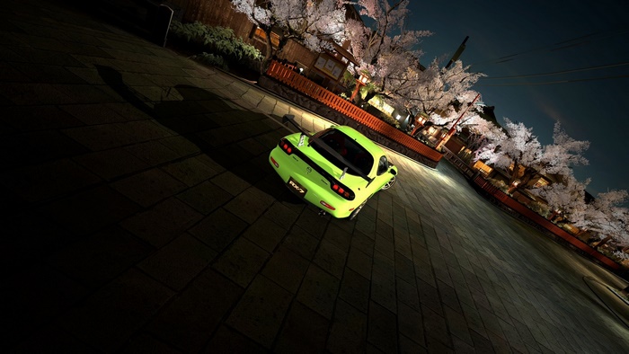 Green Mazda RX7 on a Japanese street at night