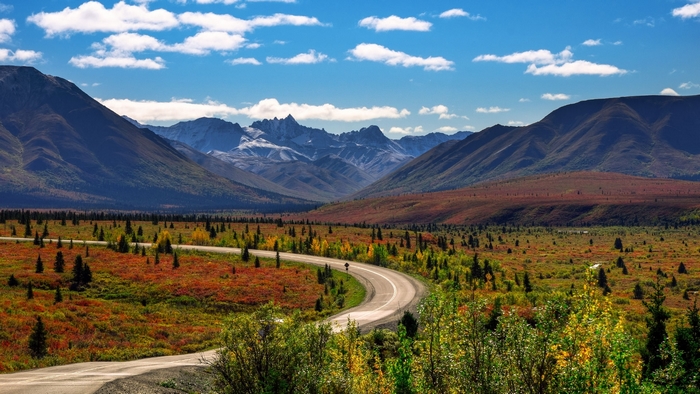 Scenic mountain landscape with a winding road in autumn
