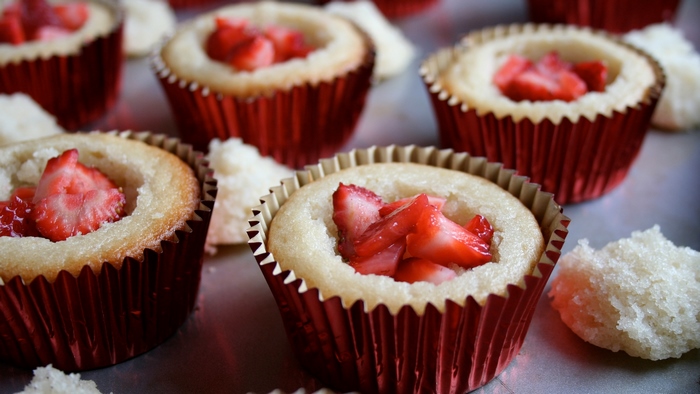Strawberry cupcakes in red wrappers