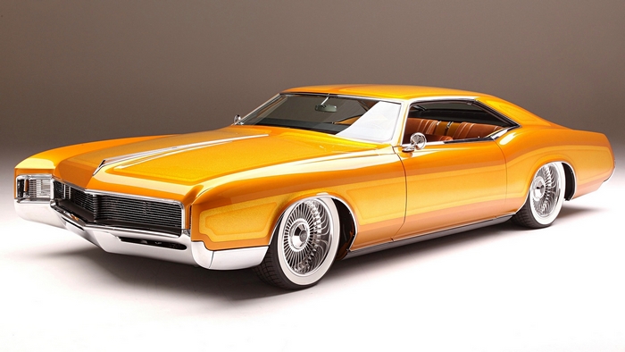 Orange classic GM car with whitewall tires