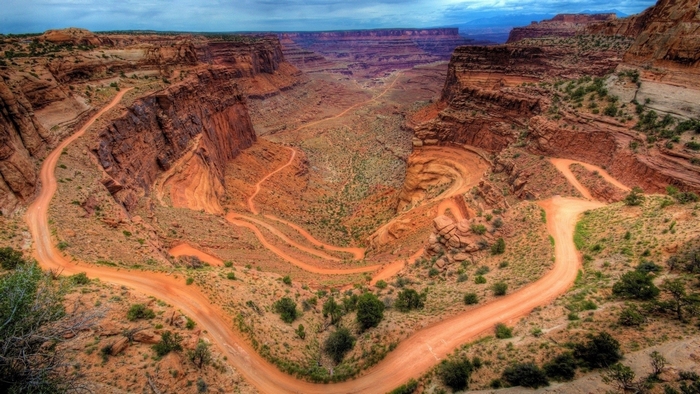 Dirt road winding through a desert canyon