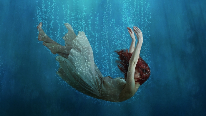 Underwater Girl with Red Hair Surrounded by Bubbles