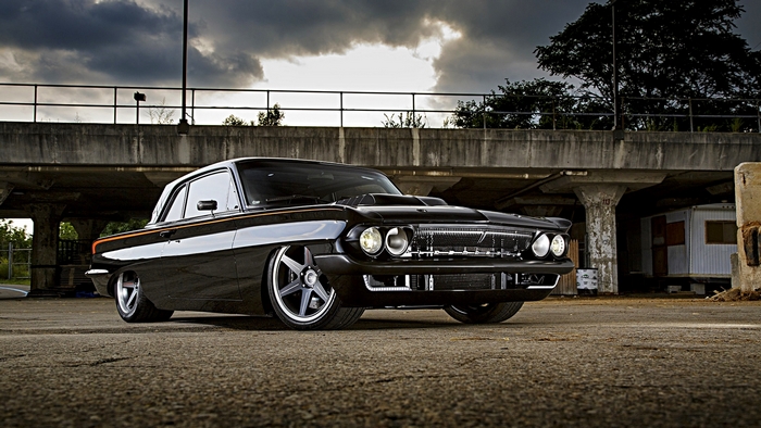 Custom black 1960s GM coupe with custom wheels