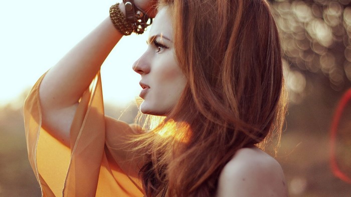 Profile of a Redhead Woman in Warm Light