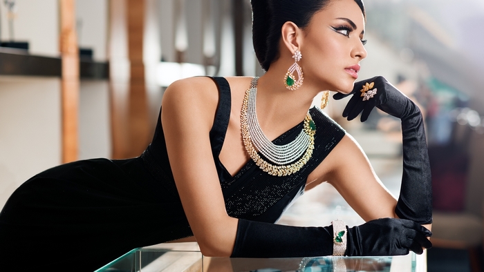 Elegant Woman in Black Dress Wearing Jewelry