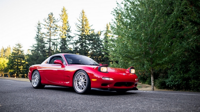 Red Mazda RX-7 sports car on a road