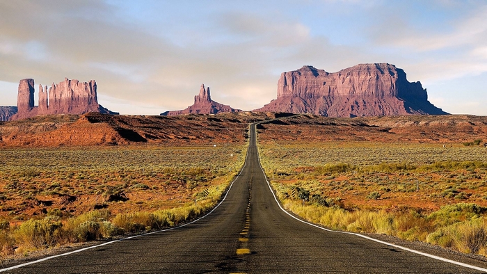 Open Road Leading to Majestic Desert Mountains
