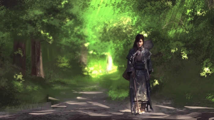 Woman with staff walking on a forest path