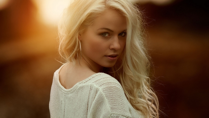 Woman with blonde hair wearing a sweater