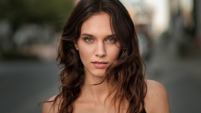 Woman with long brown hair and green eyes