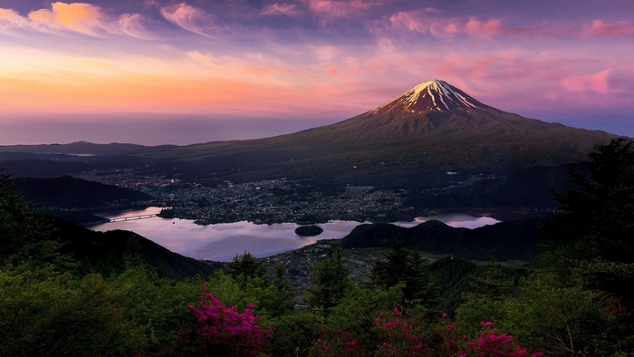 Mount Fuji at sunset with a lake and cityscape