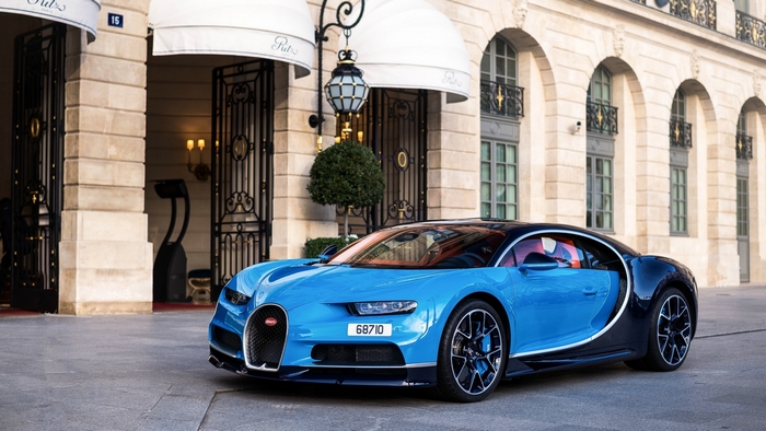 Blue Bugatti Chiron parked in front of a building