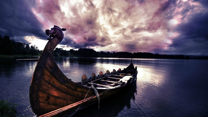 Viking longboat on a lake under dramatic clouds