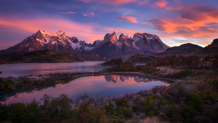 Torres del Paine mountains at sunrise with lake reflections