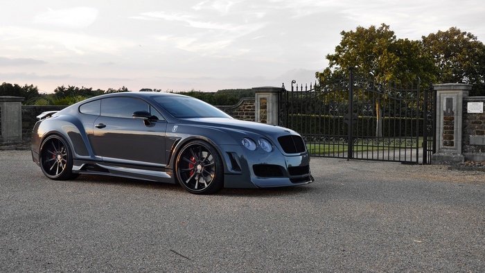 Tuned dark grey Bentley Continental GT parked on asphalt