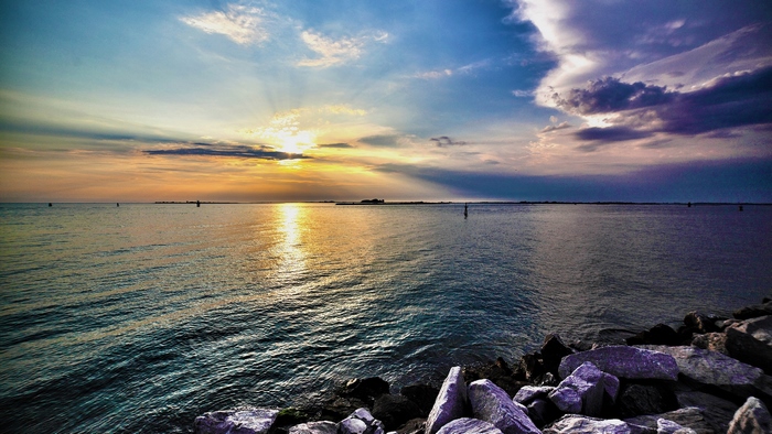 Ocean sunset with reflection and rocks