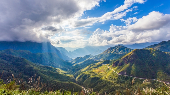 Mountain valley with sunbeams and clouds in Vietnam
