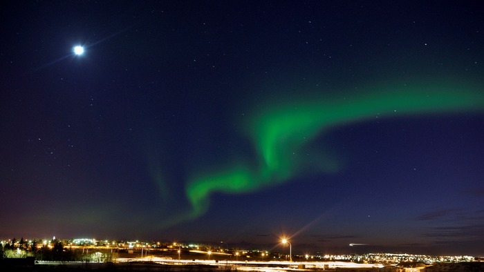 Aurora Borealis over a city at night