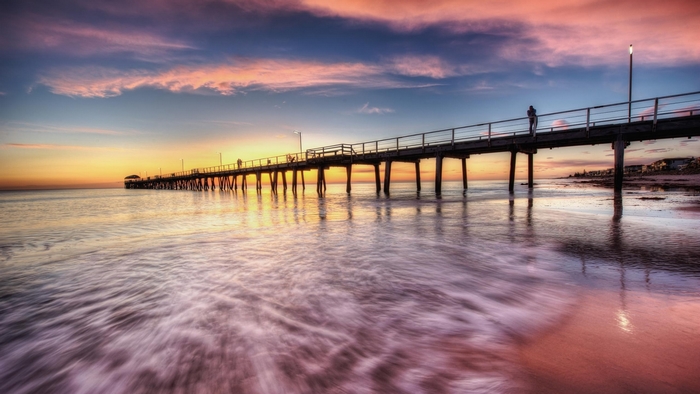 Pier at Sunrise with Colorful Sky and Ocean Waves