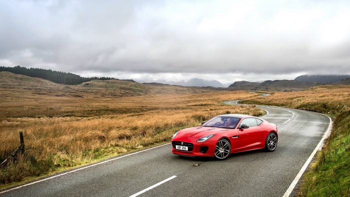 Red Jaguar F-Type car on a winding road