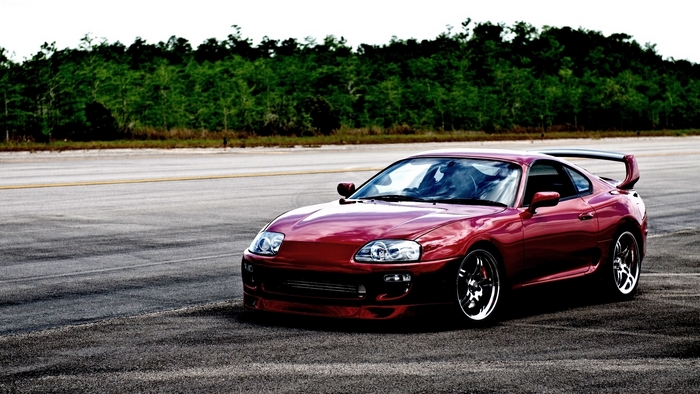 Red Toyota Supra Sports Car on Open Road