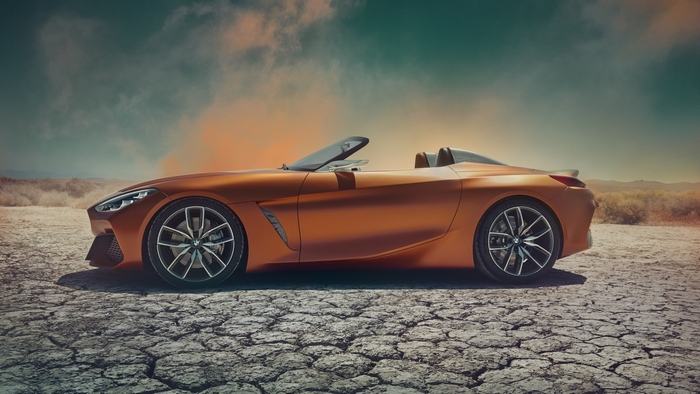 Orange BMW convertible concept car on cracked earth