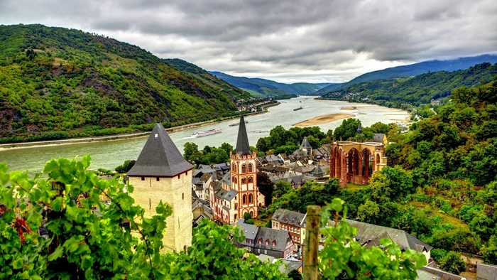 Town on a river in Germany with mountains and clouds
