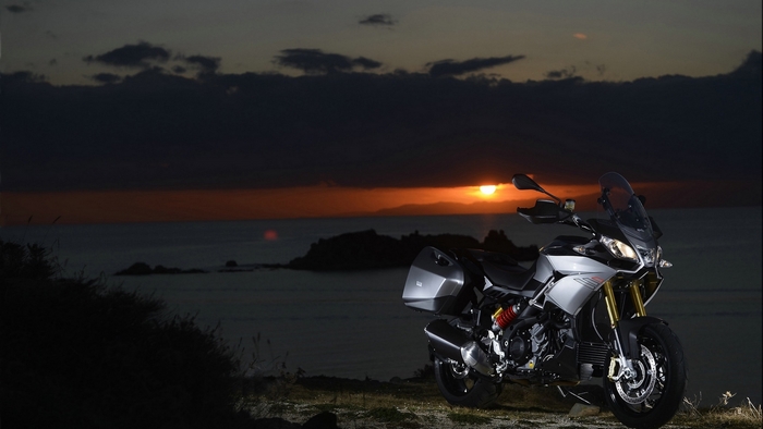Aprilia motorcycle at sunset by the ocean