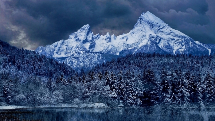 Snow-Covered Mountains and Forest under Dark Sky
