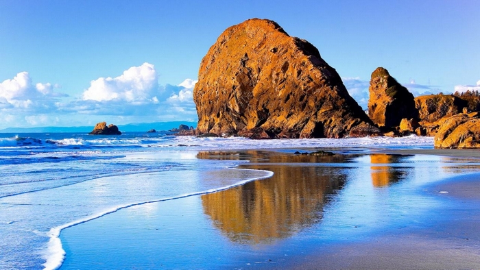 Rock Formation Reflected on a Calm Beach