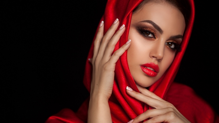 Elegant Woman in Red Hood with Dramatic Makeup